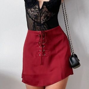 NWOT. RED LACE UP SATIN MINI SKIRT.
